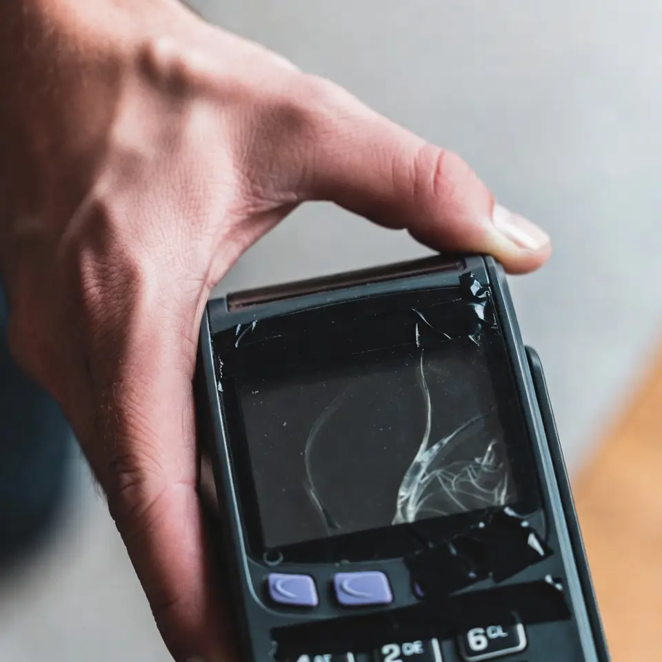 Exemplo de golpe da maquininha com visor danificado ou escuro usado para enganar clientes em pedidos de aplicativos.